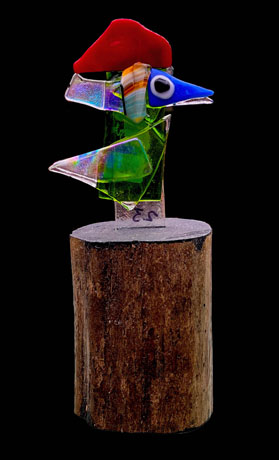 Kiln formed glass mounted on a wood base. 9.5 inch high.