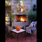 Lighted float-mounted kiln-formed glass sculpture on an outdoor fireplace