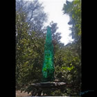 The "Green Zen" glass sculpture placed in a garden setting